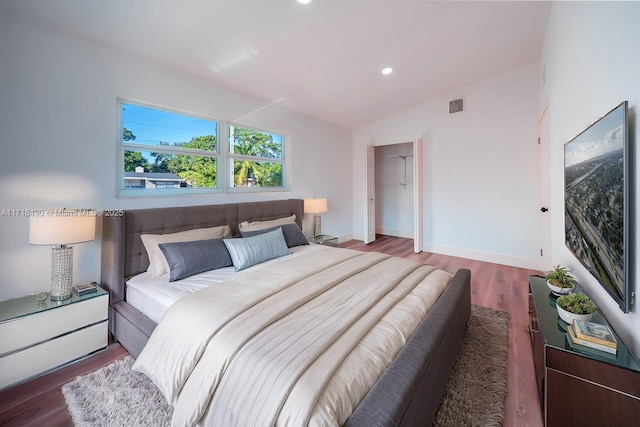 bedroom featuring dark hardwood / wood-style floors and vaulted ceiling