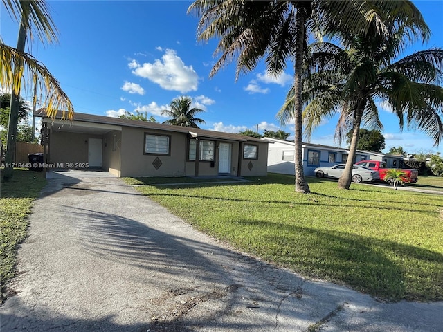 single story home featuring a front yard and a carport