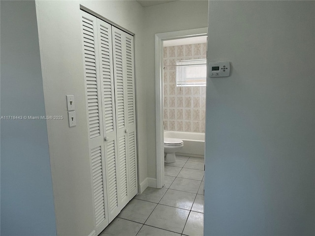 corridor with light tile patterned floors