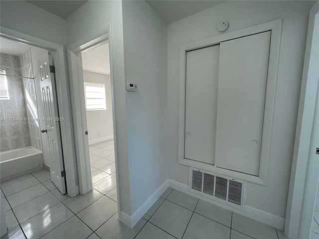 interior space with tile patterned flooring and a washtub