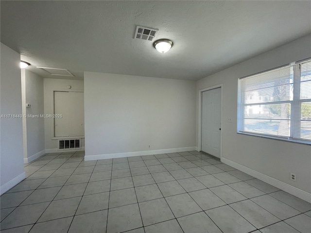 spare room featuring light tile patterned floors