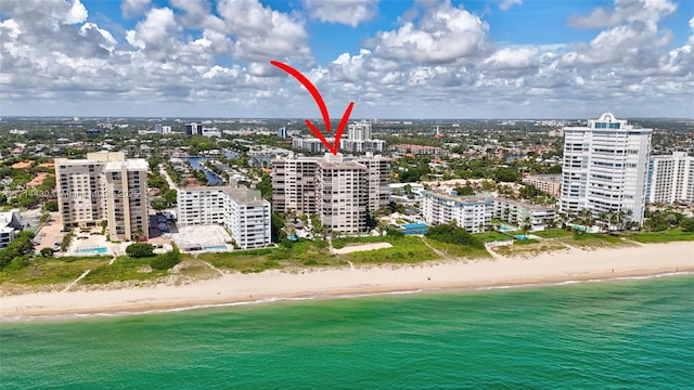 drone / aerial view featuring a view of the beach and a water view