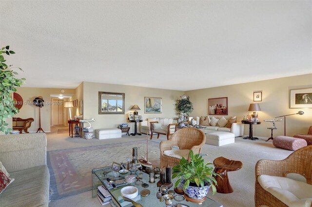 living room featuring plenty of natural light, light carpet, and a textured ceiling