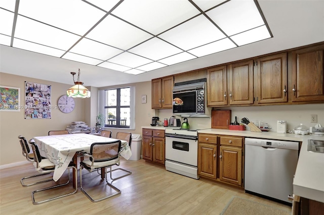 1800 S Ocean Blvd Unit 210, Lauderdale By The Sea, FL 33062 - kitchen with pendant lighting, white electric range, stainless steel dishwasher, and light wood-type flooring