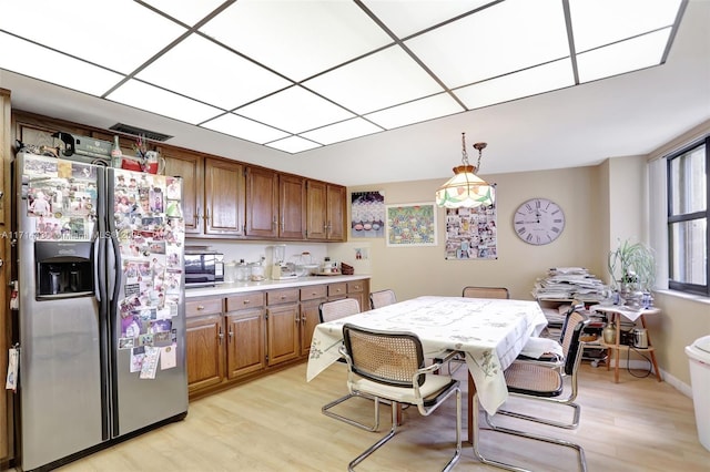 1800 S Ocean Blvd Unit 210, Lauderdale By The Sea, FL 33062 - kitchen with pendant lighting, stainless steel fridge with ice dispenser, and light hardwood / wood-style floors