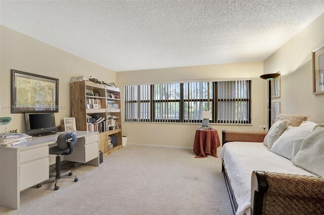 bedroom with light carpet and a textured ceiling