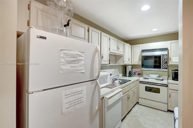 kitchen featuring sink, white appliances, white cabinets, and light tile patterned flooring