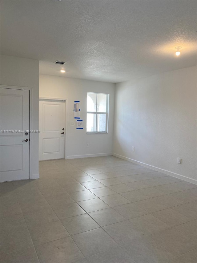 empty room featuring a textured ceiling