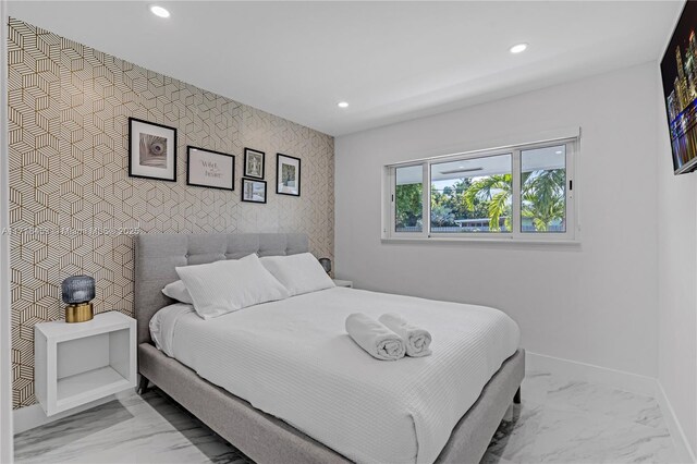 bedroom featuring wood-type flooring and a barn door