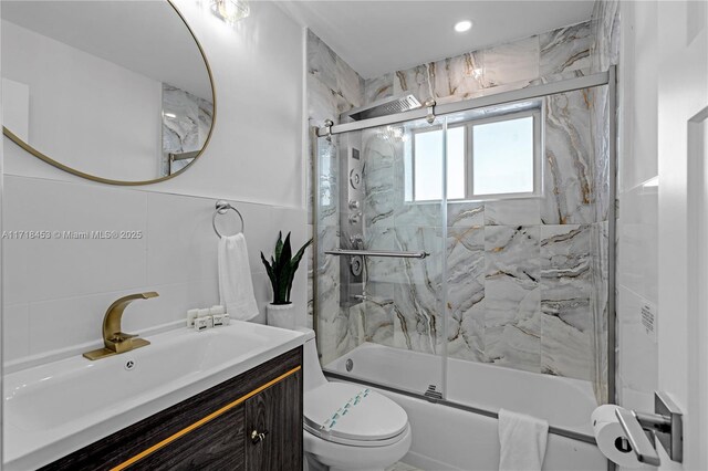 full bathroom with vanity, toilet, and bath / shower combo with glass door