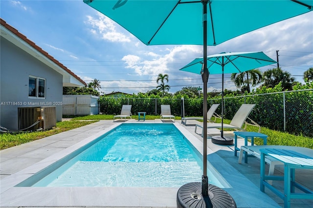 view of pool featuring a patio and central AC