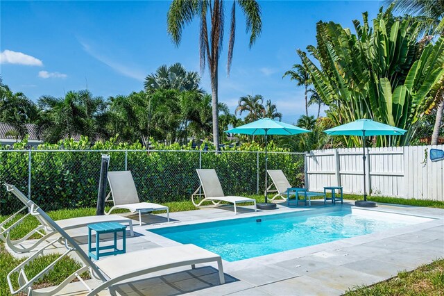 view of swimming pool with central AC and a patio area