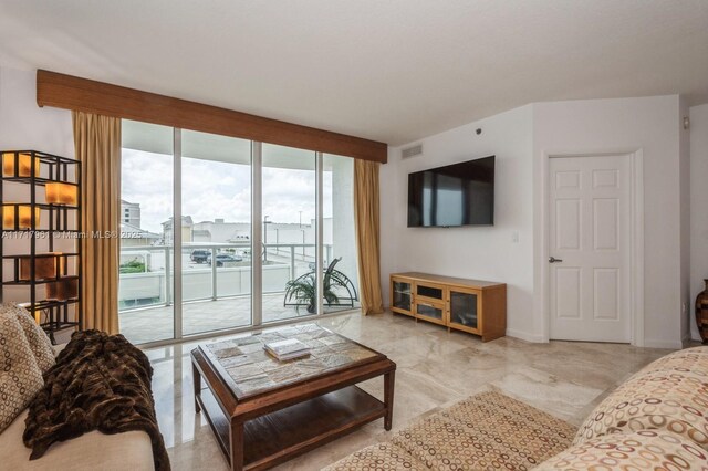 living room featuring a wall of windows