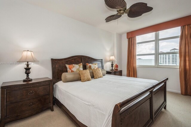 bedroom with ceiling fan and light carpet