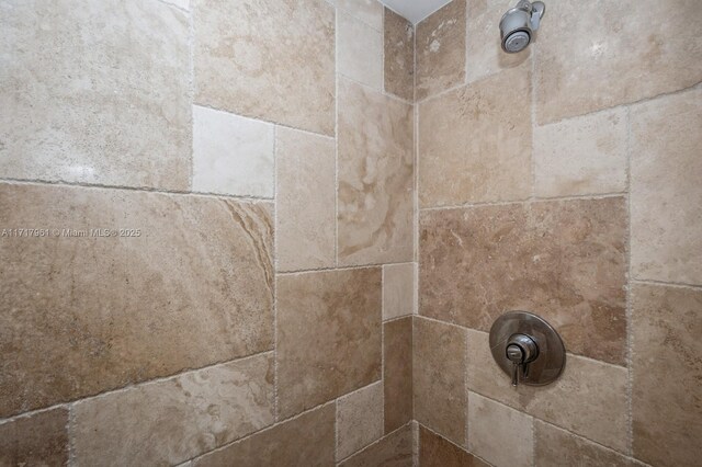 interior details with a tile shower