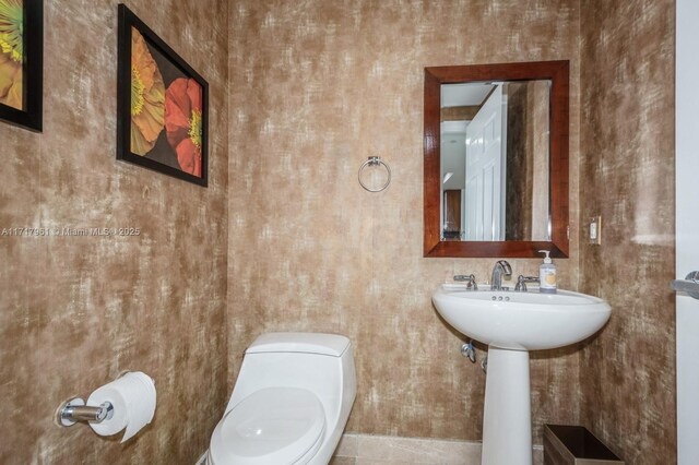 bathroom featuring tile patterned floors and toilet