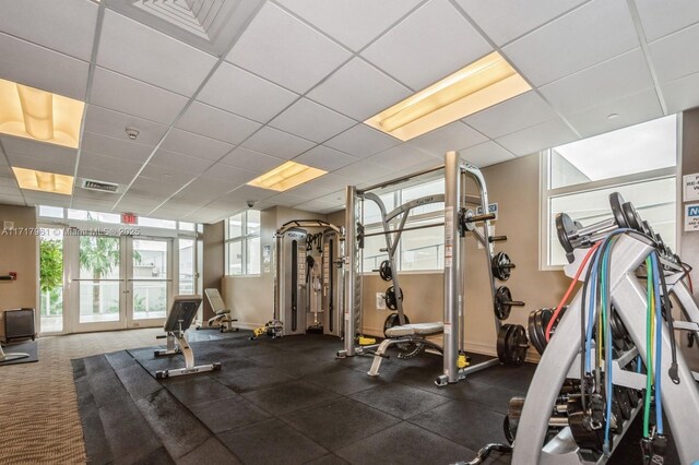 workout area featuring french doors and a drop ceiling