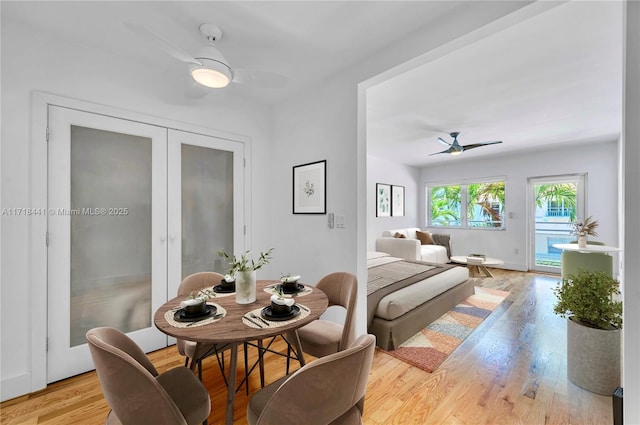 dining room with ceiling fan, light hardwood / wood-style flooring, and french doors