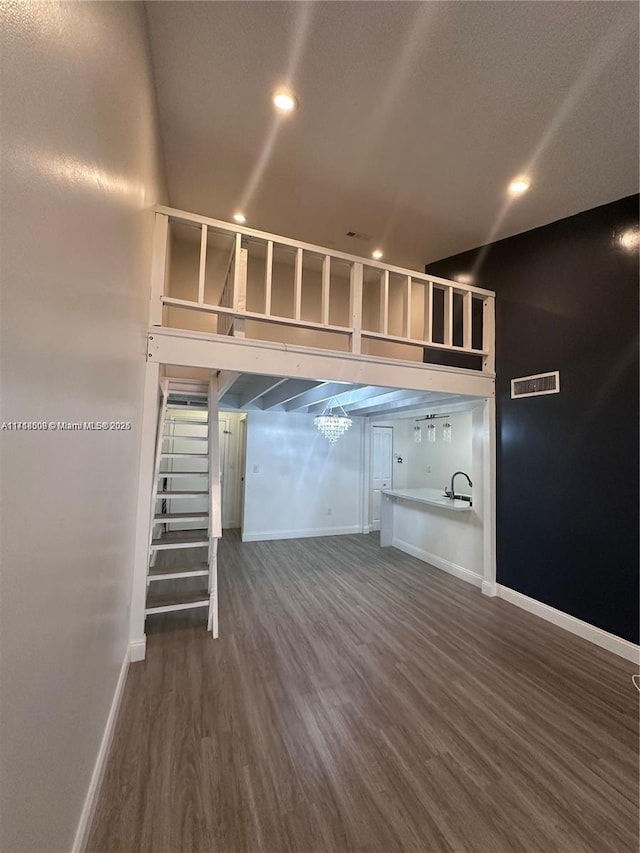 basement with dark hardwood / wood-style flooring