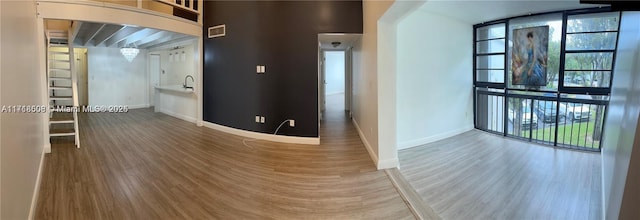 hallway with hardwood / wood-style flooring