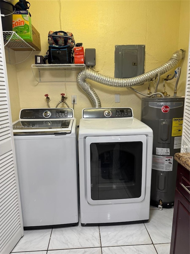 washroom featuring washing machine and dryer, electric water heater, and light tile patterned floors