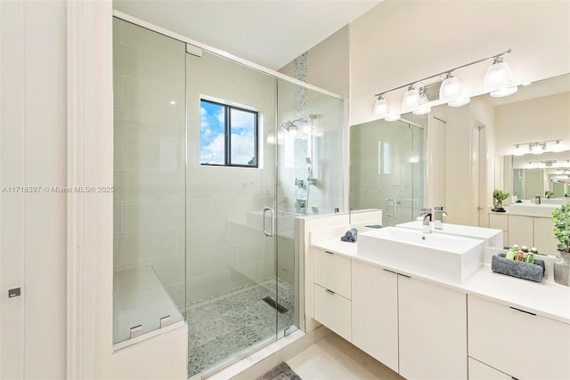 bathroom with tile patterned flooring, vanity, and an enclosed shower