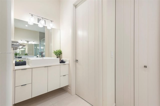 bathroom with tile patterned flooring and vanity