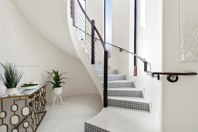 stairway with tile patterned floors