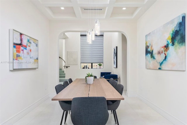 dining space with beam ceiling, a high ceiling, coffered ceiling, and a notable chandelier