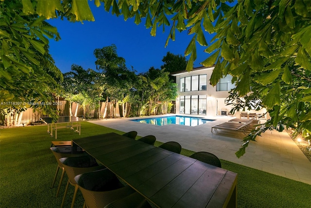 view of swimming pool featuring a patio area and a yard