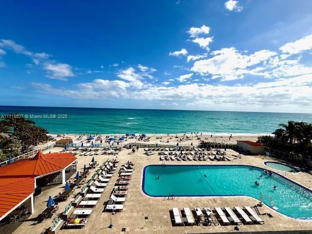 birds eye view of property with a view of the beach and a water view