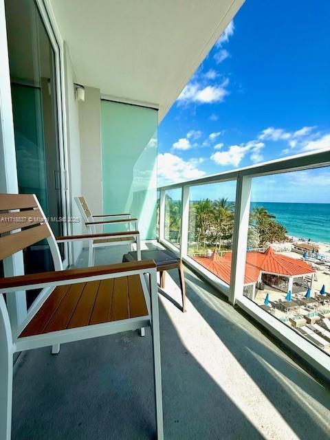 balcony featuring a water view