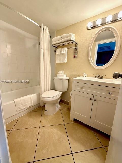 full bathroom with vanity, tile patterned flooring, shower / bathtub combination with curtain, and toilet