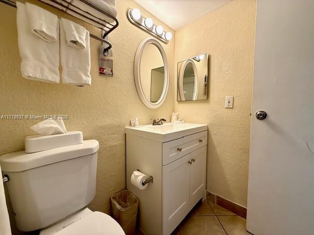 bathroom featuring tile patterned flooring, vanity, and toilet