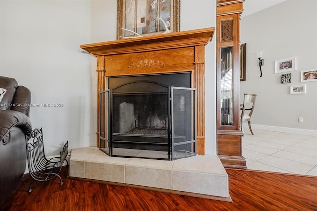 interior details featuring hardwood / wood-style floors and a fireplace