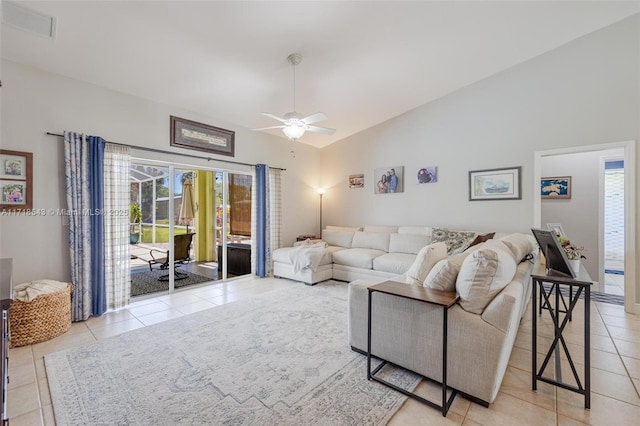 living room with light tile patterned flooring, lofted ceiling, plenty of natural light, and ceiling fan