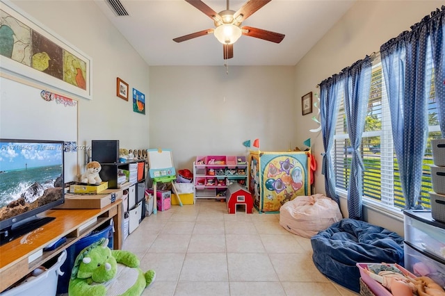 rec room with light tile patterned flooring and ceiling fan