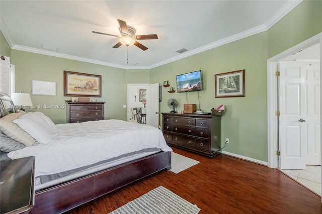 bedroom with dark wood-type flooring, ceiling fan, and crown molding