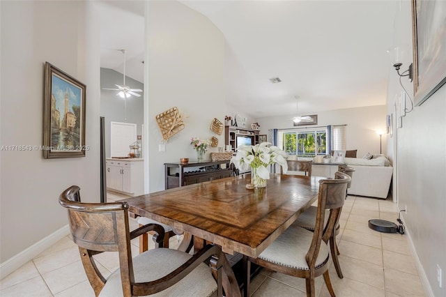 dining area with light tile patterned flooring, ceiling fan, and lofted ceiling