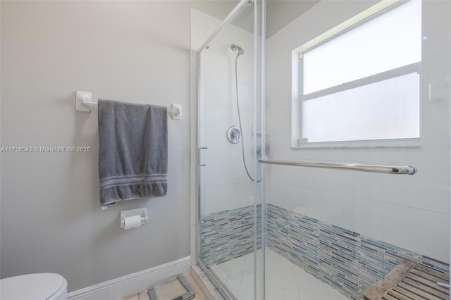 bathroom with walk in shower and toilet