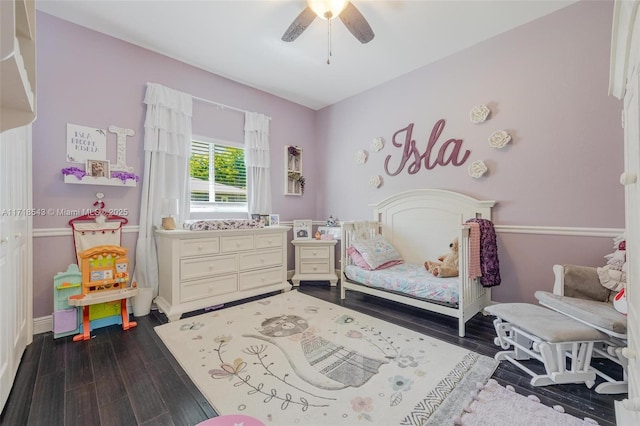 bedroom with dark hardwood / wood-style flooring and ceiling fan