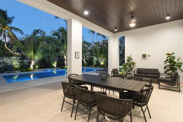 patio terrace at dusk featuring outdoor lounge area