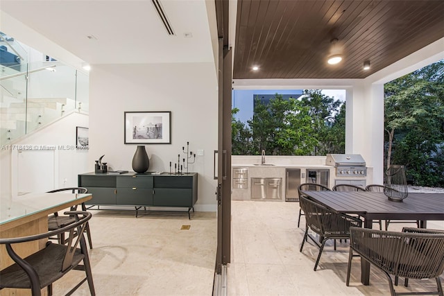 view of patio featuring area for grilling, exterior kitchen, and sink