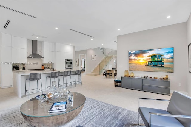 carpeted living room featuring sink