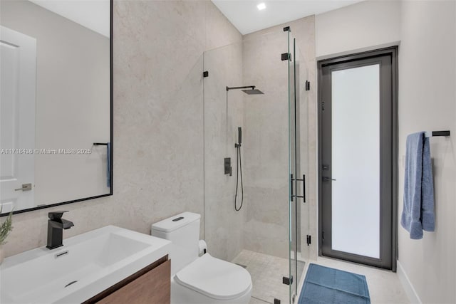 bathroom featuring vanity, toilet, and an enclosed shower