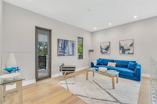 living room with plenty of natural light and light hardwood / wood-style floors