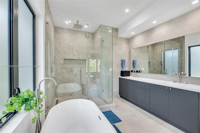 bathroom featuring vanity and separate shower and tub