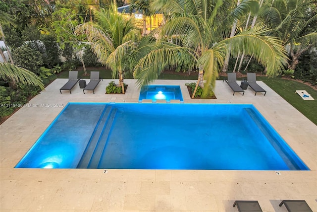 view of swimming pool featuring an in ground hot tub and a patio area