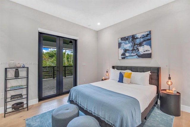 bedroom with access to outside and light hardwood / wood-style flooring