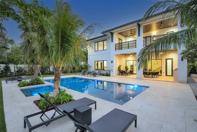 view of pool with ceiling fan and a patio